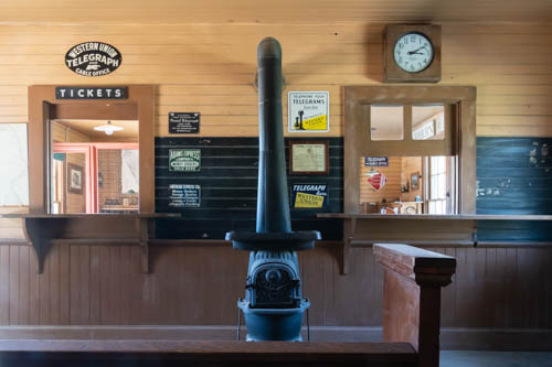 Western style potbelly stove inside ticket office of train depot